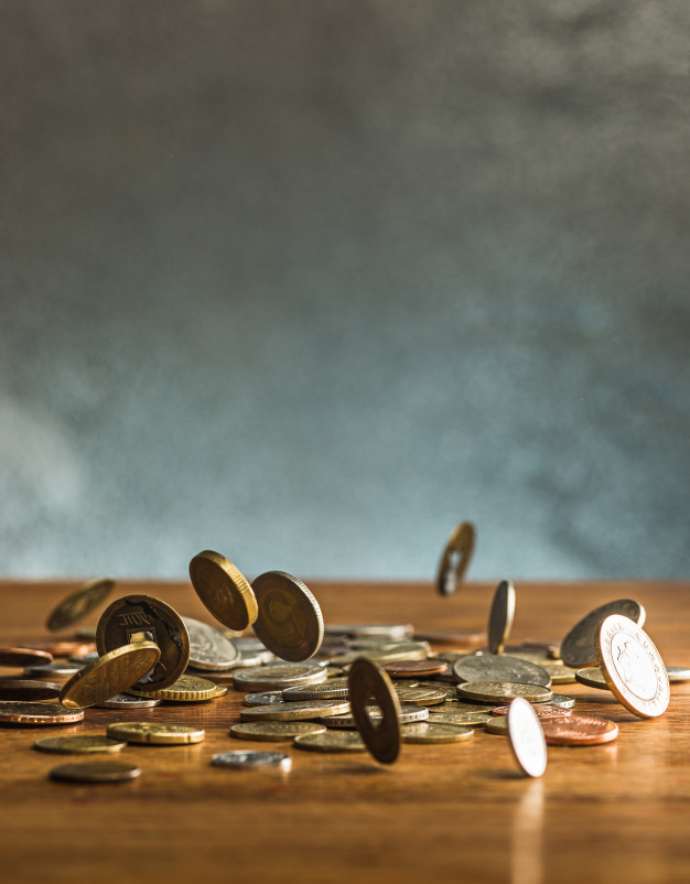silver-golden-coins-falling-coins-wooden-background_155003-13841